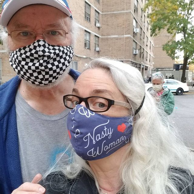 Edward James Canaday in a grey t-shirt, blue jacket and black checked mask with his wife in a black jacket and blue mask.
